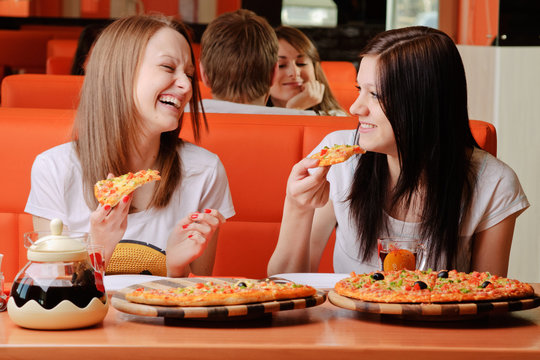 Beautiful Young Women Eating Pizza And Having Fun