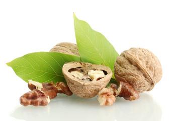 walnuts with green leaves, isolated on white