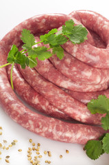 a natural raw sausage on white