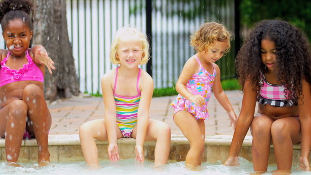 Laughing Little Girls Enjoying Swimming Pool