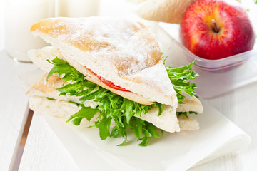School breakfast with sandwich and apple