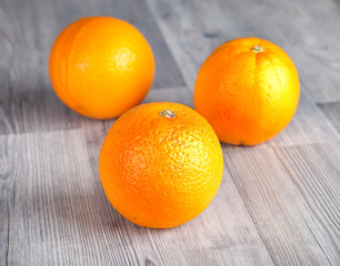 Fresh oranges on wooden table 