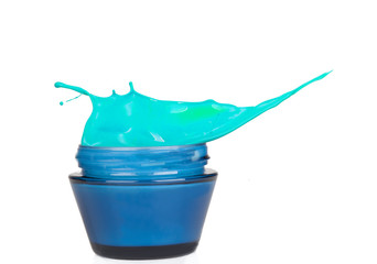 Jar of cream with splash, isolated on white background 