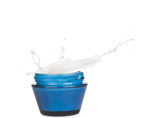 Jar of cream with splash, isolated on white background 