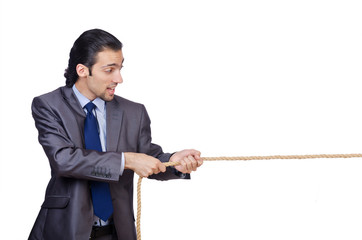 Businessman pulling rope on white