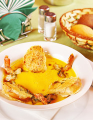 Pumpkin soup with prawns in a plate