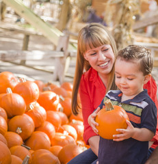 Fototapeta premium Happy Mixed Race Family at the Pumpkin Patch