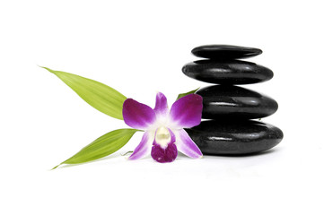 stacked stones and pink orchid with green leaf
