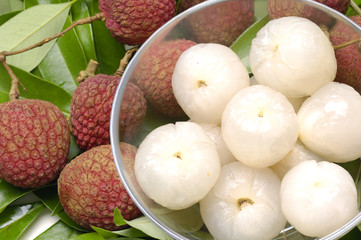 Bowl of peeled lychee with leaf