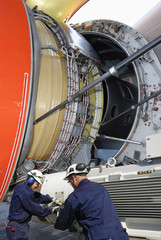 airplane mechanics with giant jet engine