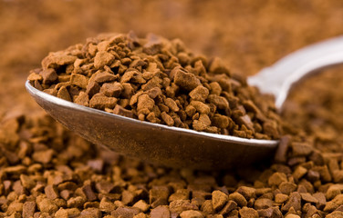 Spoon of coffee at coffe background