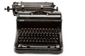 Old antique typewriter on a white background.