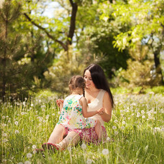 Mother playing with daughter in the park