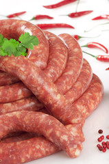 a natural raw sausage on white