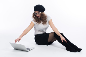 Fototapeta premium Женщина с ноутбуком сидит на полу