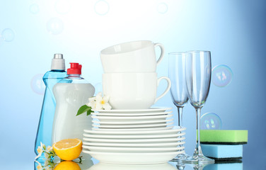 empty clean plates, glasses and cups with dishwashing liquid,