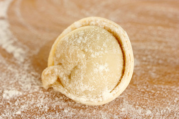 Raw Dumpling on wooden background close-up