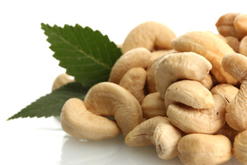 tasty cashew nuts with leaves, isolated on white