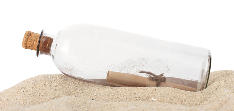 Glass bottle with note inside on sand isolated on white