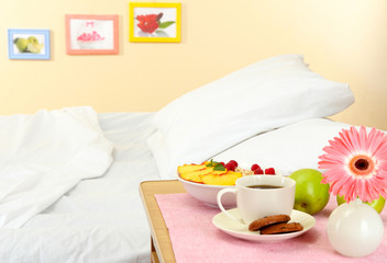 light breakfast on the nightstand next to the bed
