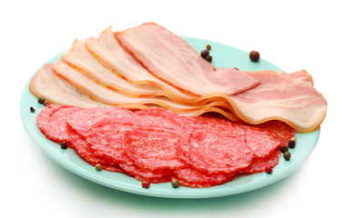 tasty bacon and sausage with spices on plate, isolated on white