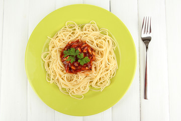 Italian spaghetti in plate on wooden table