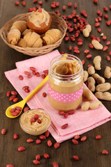 Delicious peanut butter in jar with baking