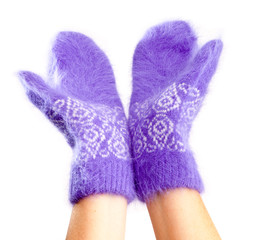 Hands in fluffy lilac mittens