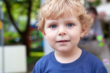 Portrait of little toddler boy with blond hairs