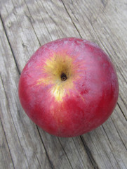 ripe apple on wooden background, close-up