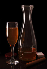 Bottle and glass of wine. Cigar and matches.