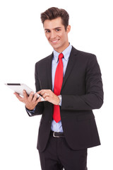 smiling business man using his tablet pad