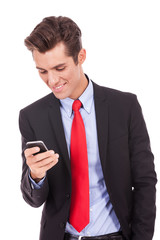 happy business man reading an SMS on smartphone
