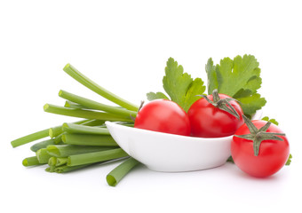 Spring onions and cherry tomato in bowl