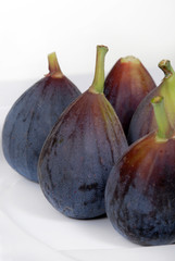 Whole, organic figs on a white plate