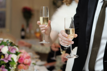 Bride and groom holding champagne glasses