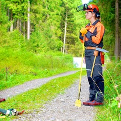 Forstarbeiterin mit Schutzkleidung im Wald