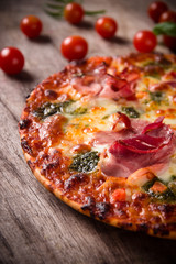 Tasty Italian pizza on wooden background