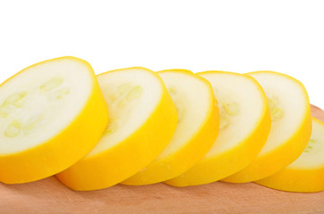 Yellow vegetable marrow (zucchini) on wooden board