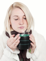 Young blonde woman enjoys a cup of tea - isolated