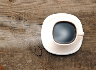 Hot coffee on old wooden background