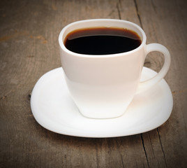 Cup of coffee on an old wooden background