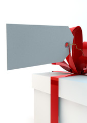 White gift box with red ribbons and a tag