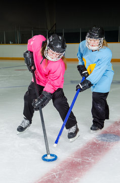 Ringette Players in Action at Hockey Rink