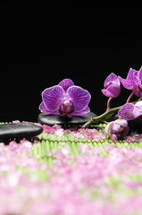 orchid with zen stone and pile of sea salt with green mat