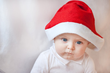 Baby boy with Christmas cap and balls