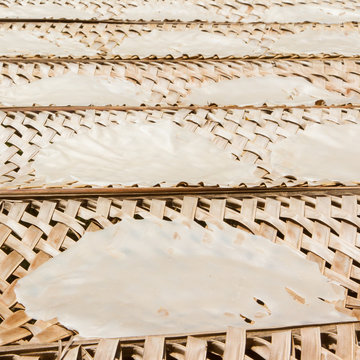 Rice paper drying at a bamboo frame