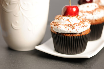Cupcakes with whipped cream and cherry