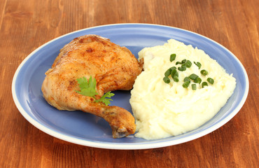 roasted chicken leg with mashed potato in the plate
