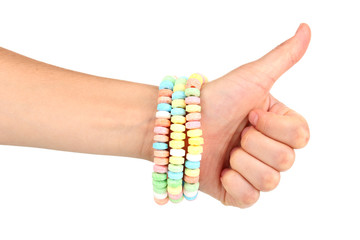 Color candies on hand isolated on white